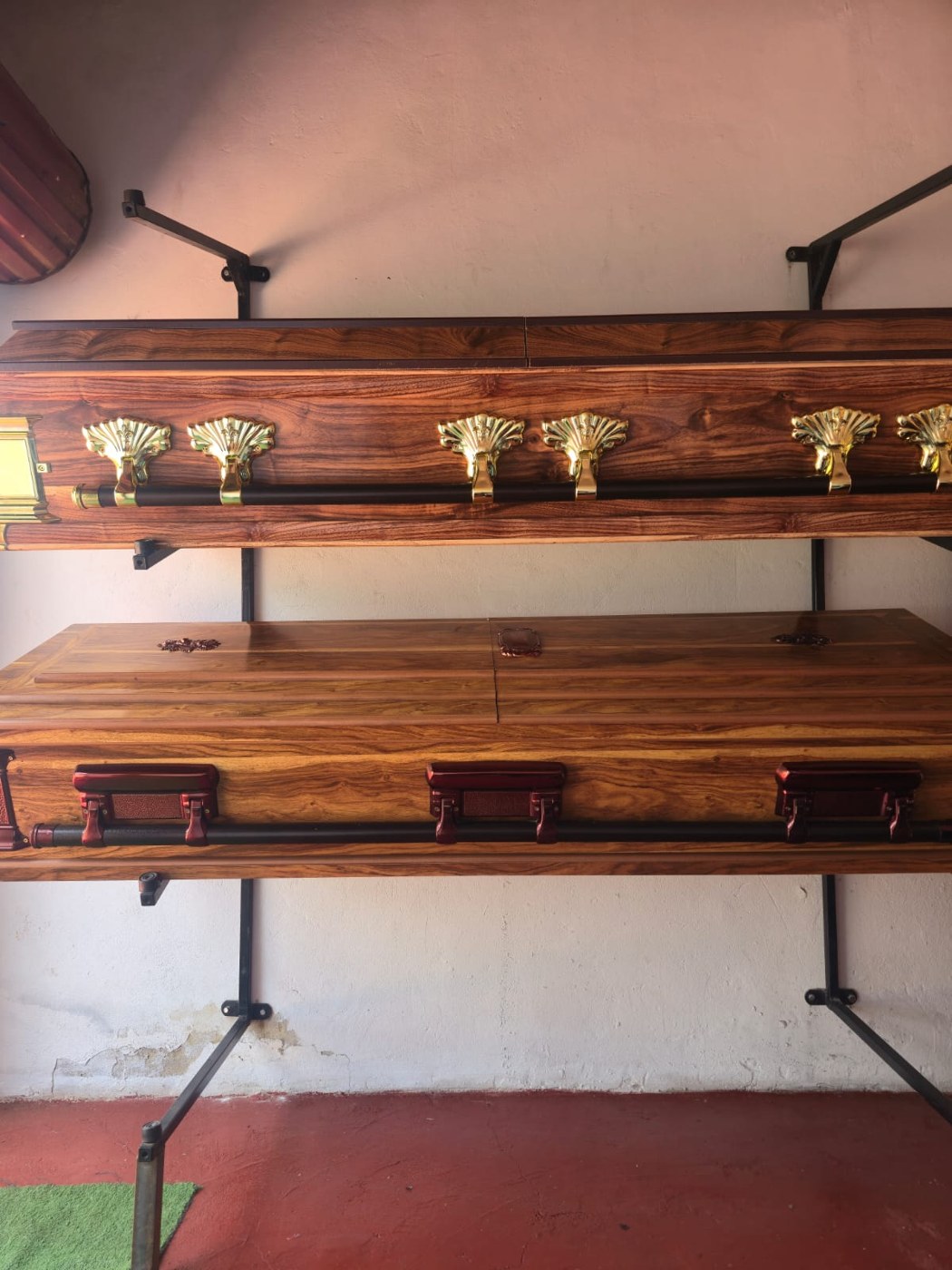Wooden coffin options displayed on shelving